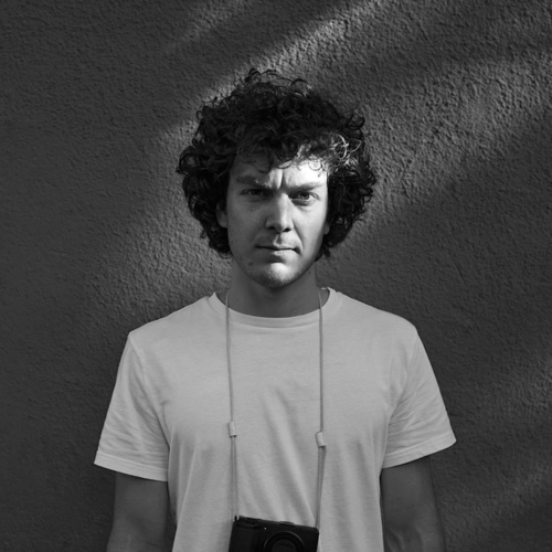 felix_gaertner_headshot Black and white headshot of photographer Felix Gaertner wearing a camera around his neck